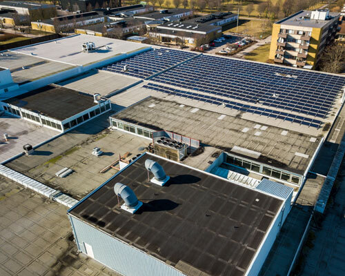Aerial View Of Many Photo Voltaic Solar Panels Mounted Of Indust