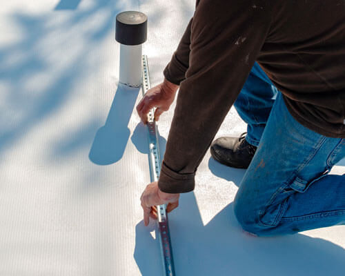 Worker With A Heat Gun Is Welding Pvc Sheets For Waterproofing A Terrace. Selective Focus
